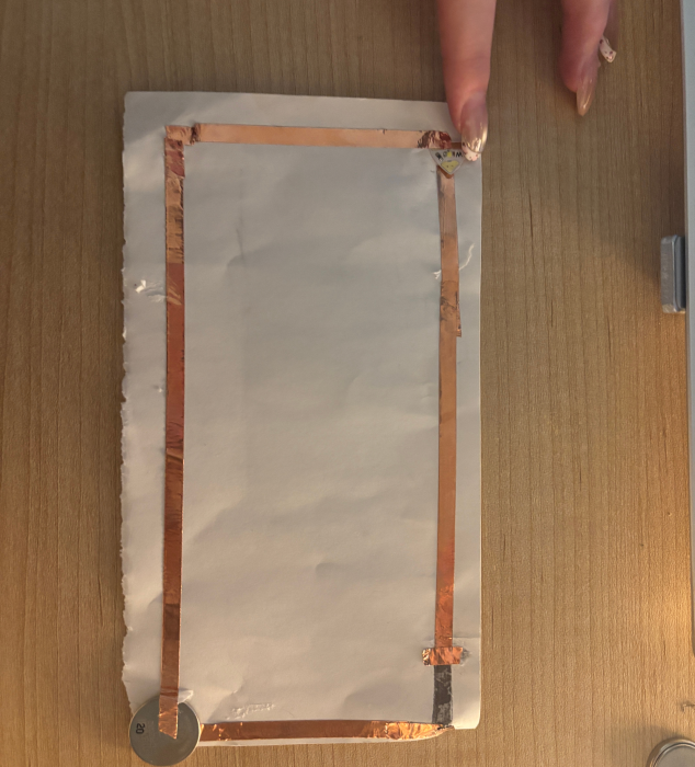A rectangular-shaped paper circuit frame.