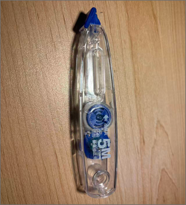 A correction tape with a transparent casing.