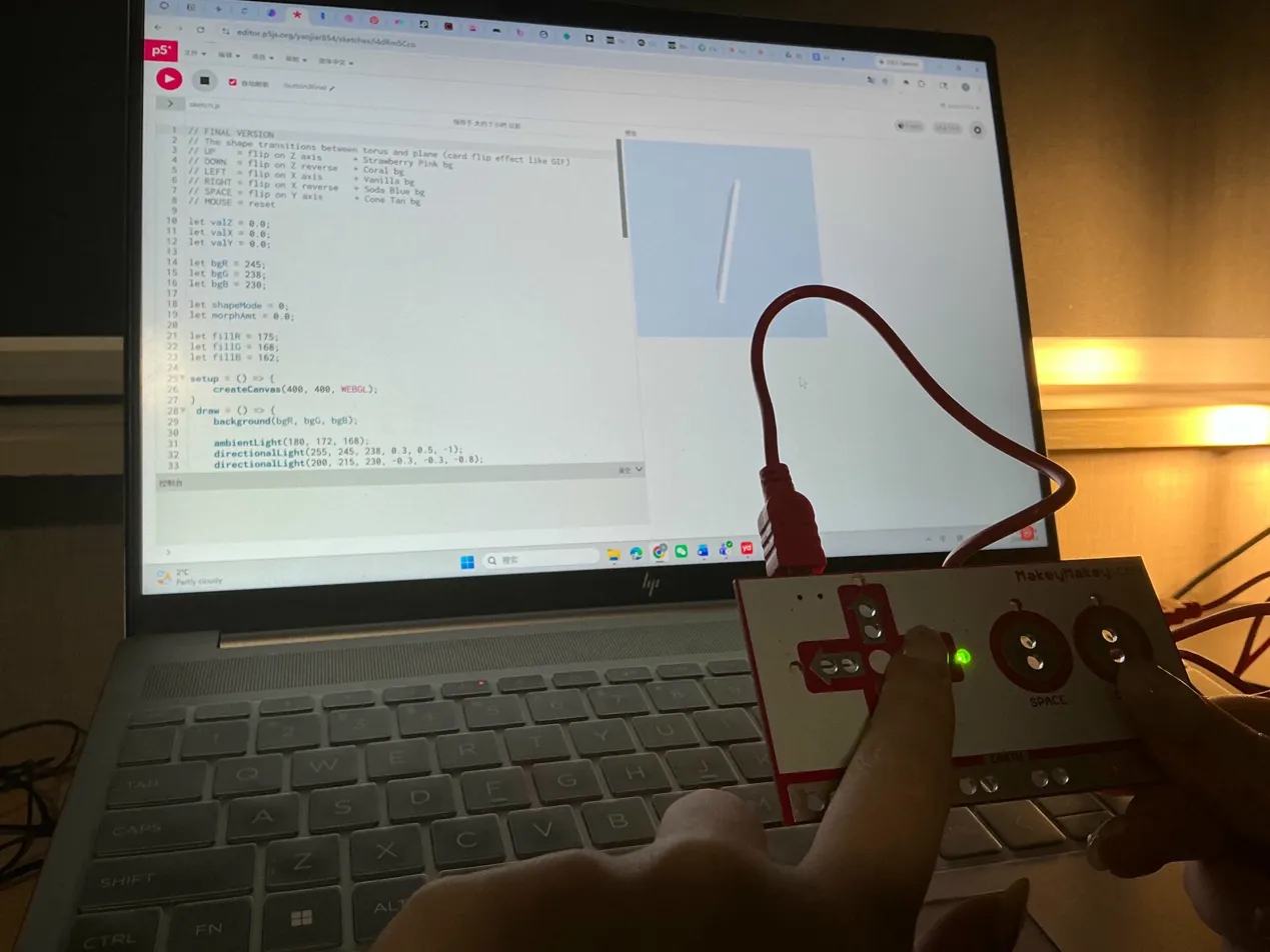 Laptop displays a white diagonal flat plane rotating in WEBGL 3D space, Makey Makey held sideways.